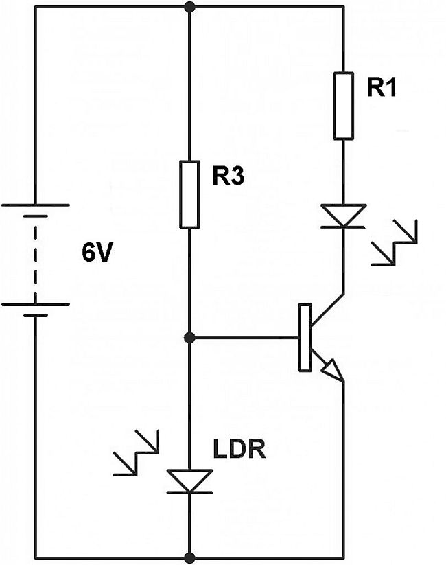 Light dependent resistor in a potential divider and transistor switch