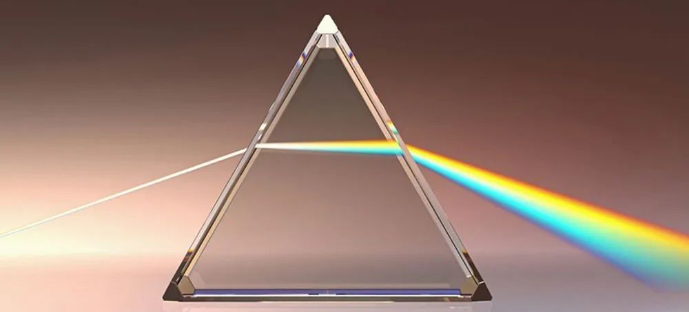 Enhanced image showing the production of a rainbow through disperion in a triangular prism.